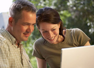 Couple looking at finances on laptop