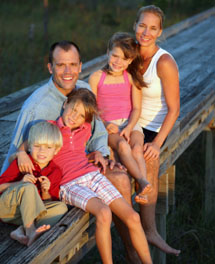 Family sitting on removal home stump